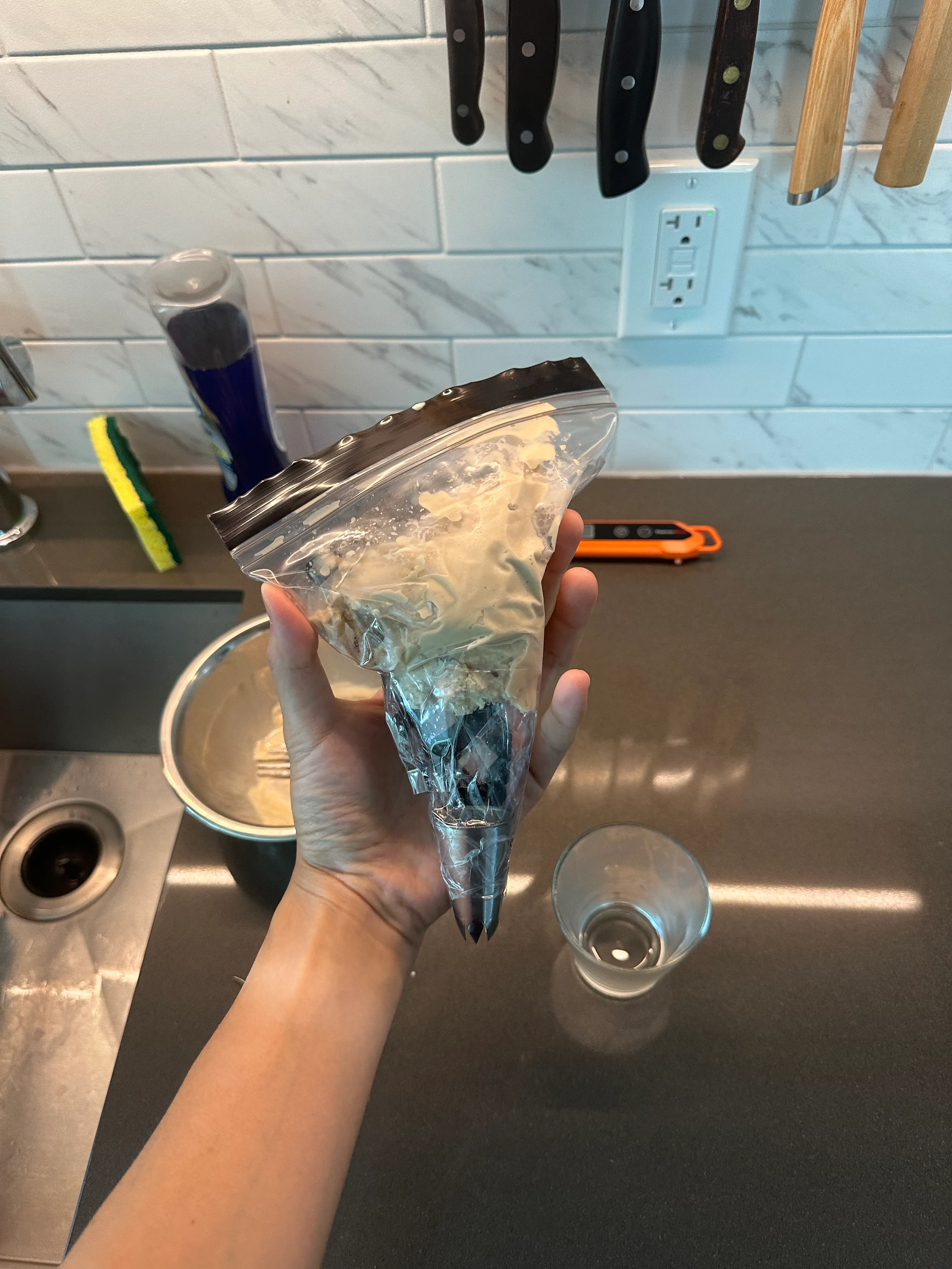 DIY piping bag by taping a zip lock bag into a cone, then inserting the piping tip.